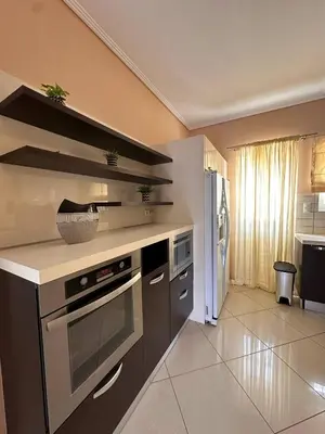 a kitchen with a stove and a counter top at La Maison in Áyios Nikólaos