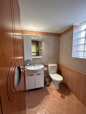 a bathroom with a toilet and a sink at La Maison in Áyios Nikólaos