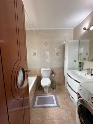 a bathroom with a toilet and a tub and a sink at La Maison in Áyios Nikólaos