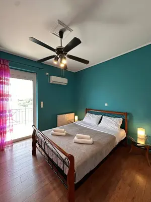 a bedroom with a bed with two towels on it at La Maison in Áyios Nikólaos
