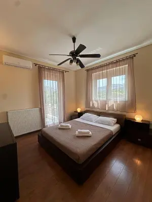 a bedroom with a bed with two towels on it at La Maison in Áyios Nikólaos