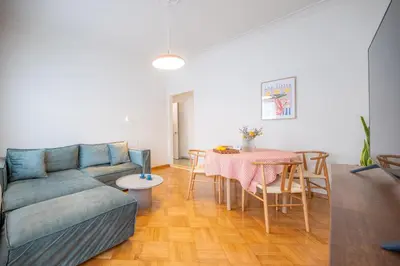 a living room with a couch and a table at Aegis Filoppapou suites - Olive in Athens