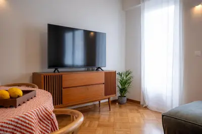 a living room with a flat screen tv on a dresser at Aegis Filoppapou suites - Olive in Athens