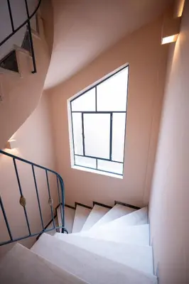 a staircase in a room with a window at Aegis Filoppapou suites - Olive in Athens