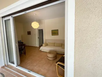 a view of a living room with a couch at Saronida Beach Nest Apartment in Saronida