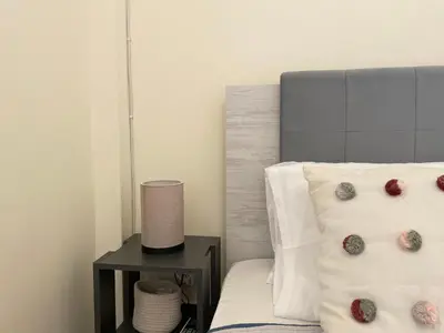 a bedroom with a bed and a nightstand with donuts on it at Saronida Beach Nest Apartment in Saronida