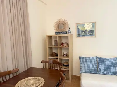 a living room with a table and a couch at Saronida Beach Nest Apartment in Saronida