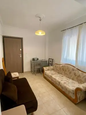 a living room with a couch and a table at Kalamaki Philoxenia in Athens
