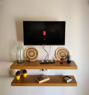 a shelf with a tv on a white wall at Apartment with a view in Athens in Athens
