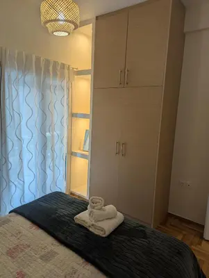 a bedroom with a bed with towels on it at Apartment with a view in Athens in Athens