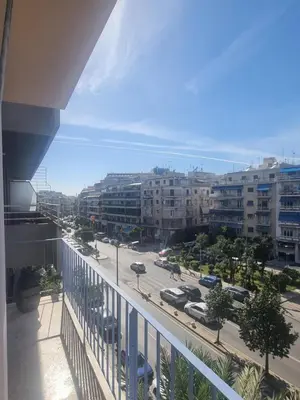 a view of a city with buildings and a street at Apartment with a view in Athens in Athens