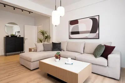 a living room with a couch and a coffee table at Luxury Apartment next to the National Museum in Athens