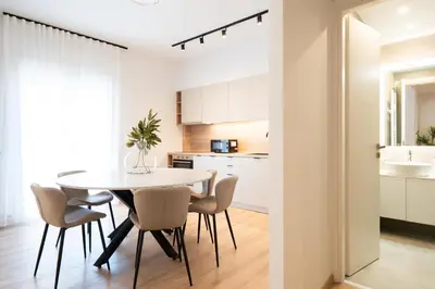 a kitchen and dining room with a table and chairs at Luxury Apartment next to the National Museum in Athens