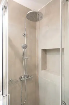 a shower with a shower head in a bathroom at Luxury Apartment next to the National Museum in Athens