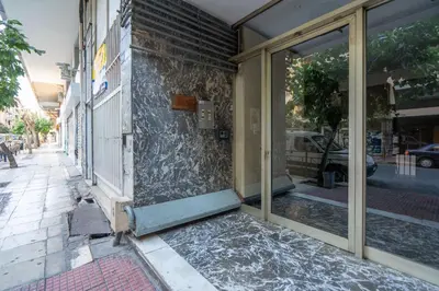 a glass door of a building on a street at Luxury Apartment next to the National Museum in Athens