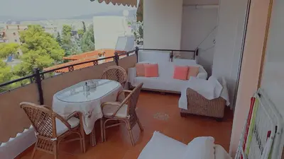 a balcony with a table and chairs and a couch at ''Athens Light'' luxury spacy appartment, Agia Paraskevi in Athens