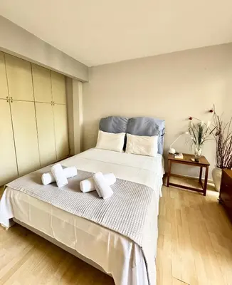 a bedroom with a large bed with towels on it at Varkiza Stay in Varkiza