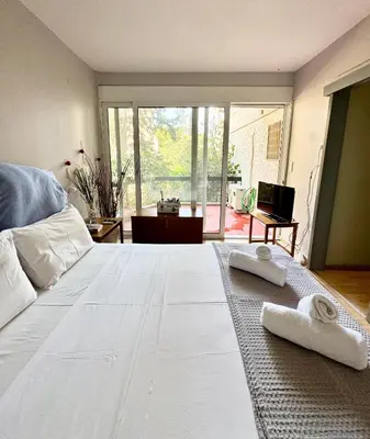 a bedroom with a large white bed with towels on it at Varkiza Stay in Varkiza