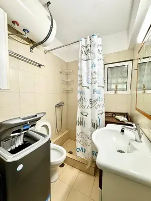 a bathroom with a sink and a toilet and a shower curtain at Varkiza Stay in Varkiza