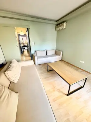 a living room with a couch and a table at Varkiza Stay in Varkiza