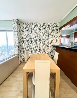 a kitchen with a wooden table and chairs in a room at Varkiza Stay in Varkiza