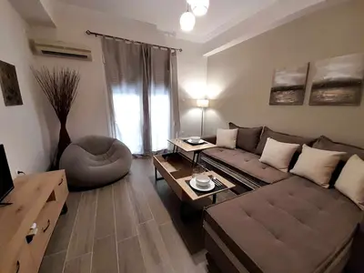 a living room with a couch and a table at Irene Luxe Loft in Piraeus