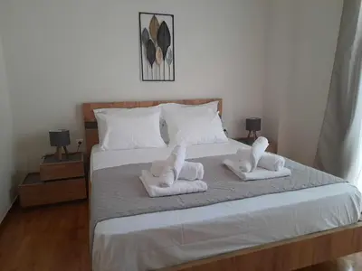 a bedroom with a bed with towels on it at Irene Luxe Loft in Piraeus