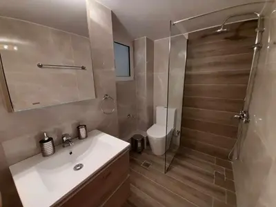 a bathroom with a white sink and a shower at Irene Luxe Loft in Piraeus