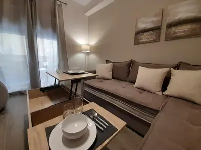 a living room with a couch and a table at Irene Luxe Loft in Piraeus