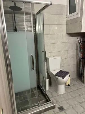a bathroom with a toilet and a glass shower at Thissio Apartment by Life Houses in Athens