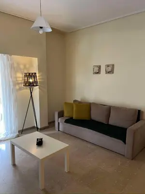 a living room with a couch and a table at Thissio Apartment by Life Houses in Athens