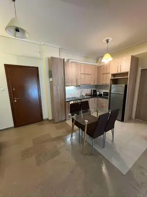 an empty kitchen with a table and chairs in a room at Thissio Apartment by Life Houses in Athens