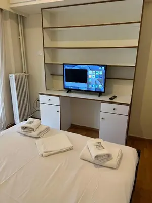 a bedroom with a bed and a tv on a desk at Thissio Apartment by Life Houses in Athens