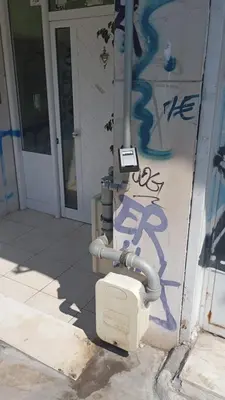 a house with graffiti on the side of it at Thissio Apartment by Life Houses in Athens