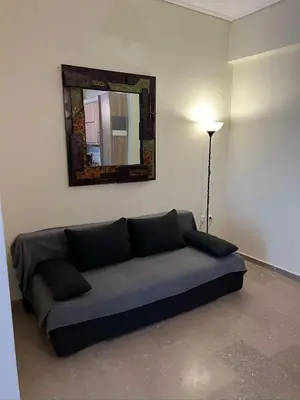 a couch in a room with a mirror and a lamp at Thissio Apartment by Life Houses in Athens