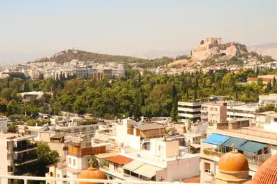 a view of a city with a castle on a hill at Rooftop studio with Acropolis view just next to Panathenaic Stadium - 280 Athens view in Athens