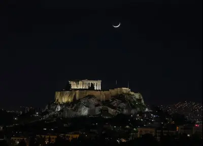 a view of the acropolis at night with the moon at Rooftop studio with Acropolis view just next to Panathenaic Stadium - 280 Athens view in Athens