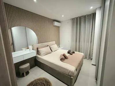 a small bedroom with a bed and a mirror at Floral Home 2 - 1st floor apt with private parking! in Athens