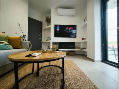 a living room with a coffee table and a tv at Floral Home 2 - 1st floor apt with private parking! in Athens