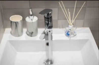 a bathroom sink with a faucet and a toothbrush at Studio In The Heart Of Kallithea in Athens