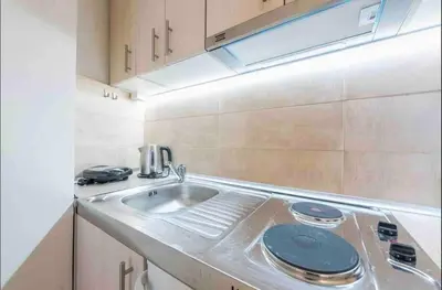 a kitchen with a sink and a counter top at Studio In The Heart Of Kallithea in Athens