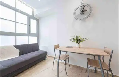 a living room with a couch and a table at Studio In The Heart Of Kallithea in Athens