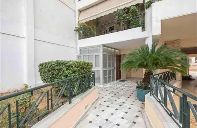 a balcony of a building with a palm tree at Studio In The Heart Of Kallithea in Athens