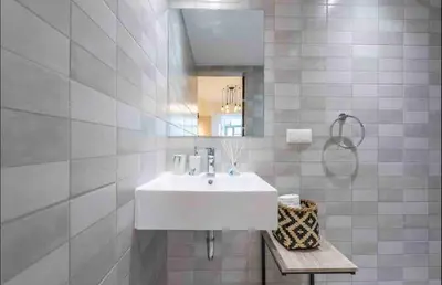 a bathroom with a white sink and a mirror at Studio In The Heart Of Kallithea in Athens