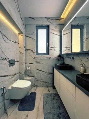 a bathroom with a white toilet and a sink at Seaside Charming Apartment in Alimos in Athens