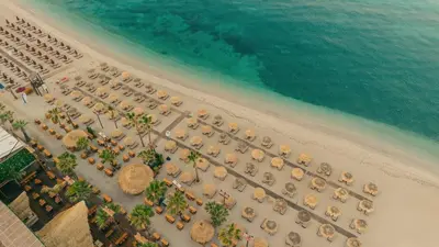 an overhead view of a beach with chairs and umbrellas at Seaside Charming Apartment in Alimos in Athens