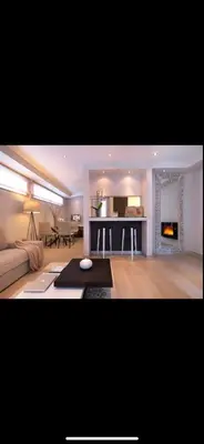a living room with a couch and a fireplace at Small Villa in Palaio Psichiko in Athens