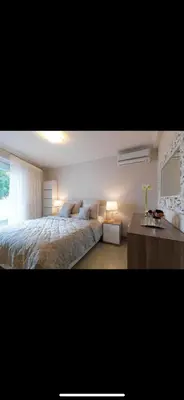a bedroom with a large bed and a table at Small Villa in Palaio Psichiko in Athens