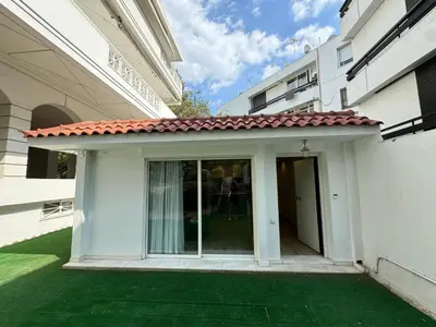 a small white building with a red roof at Small Villa in Palaio Psichiko in Athens