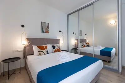 a hotel room with two beds and a mirror at Elvis 2-Bedroom Apartment in Athens in Athens